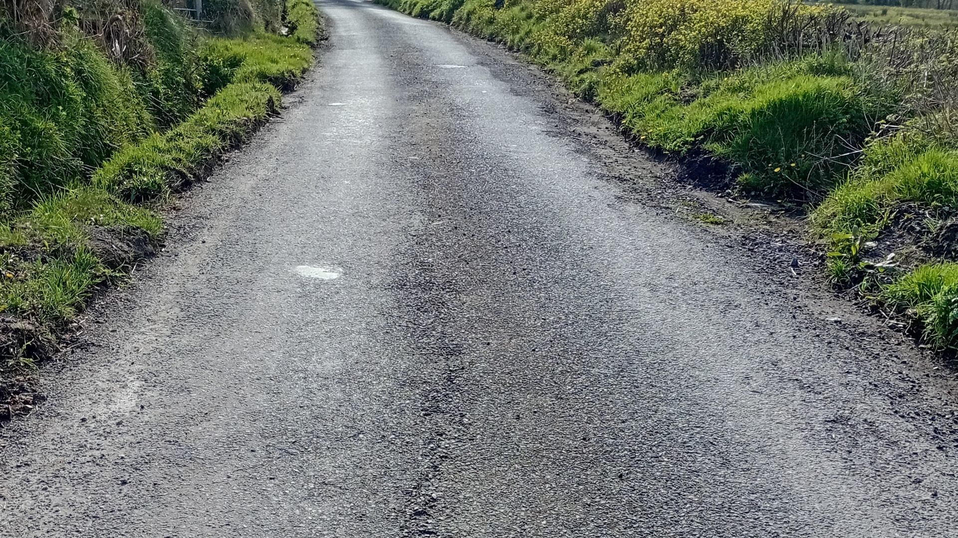 Ballinakillew Road before Roadteam recycling works showing worn rural road surface