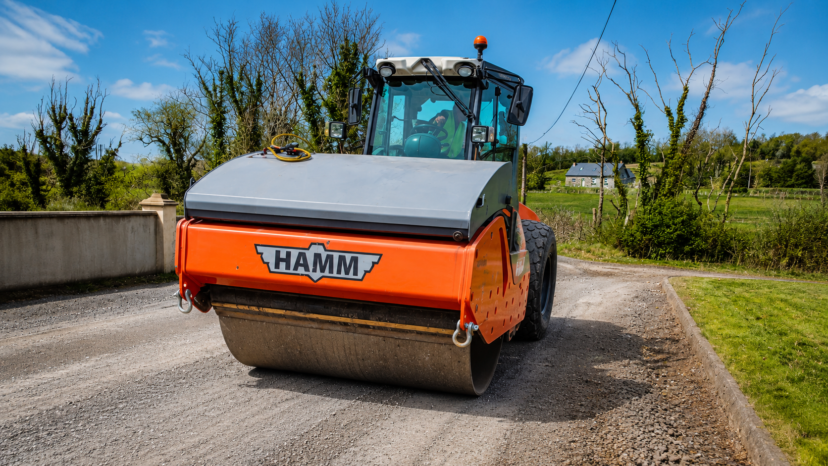 Hamm H11i 12 tonne roller compacting road surface on site
